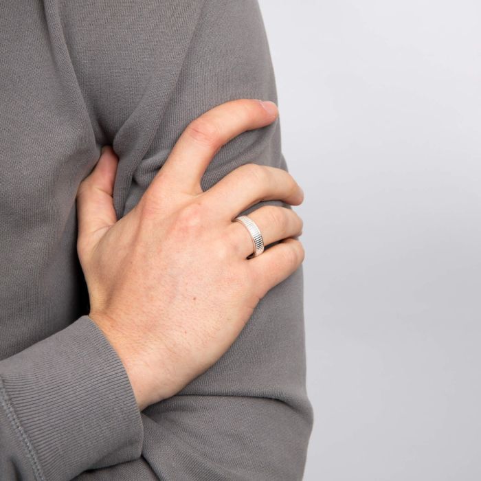 men hand wearing silver ridged spinner ring