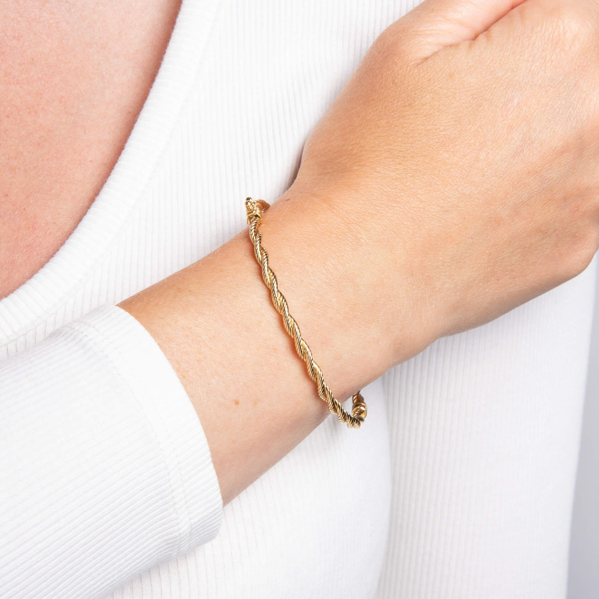 woman arm wearing 9ct Gold Rope Twist Bangle gold 