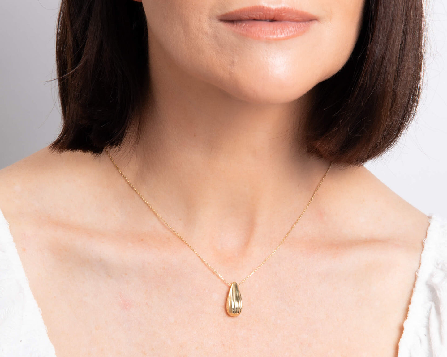 woman wearing Gold Ridged Teardrop Necklace